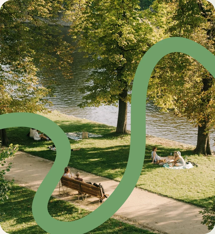 People relaxing in a riverside park